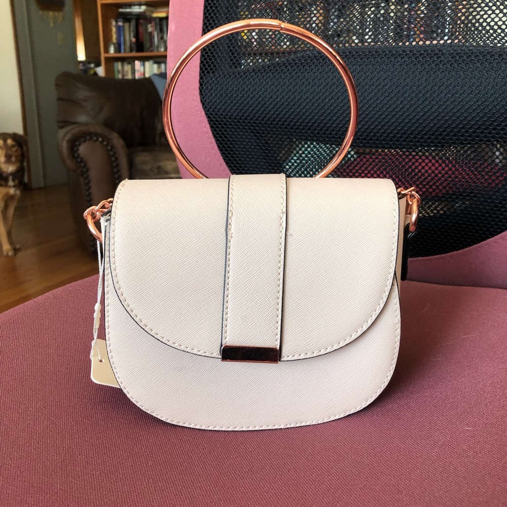 Cream crossbody with rose gold details.